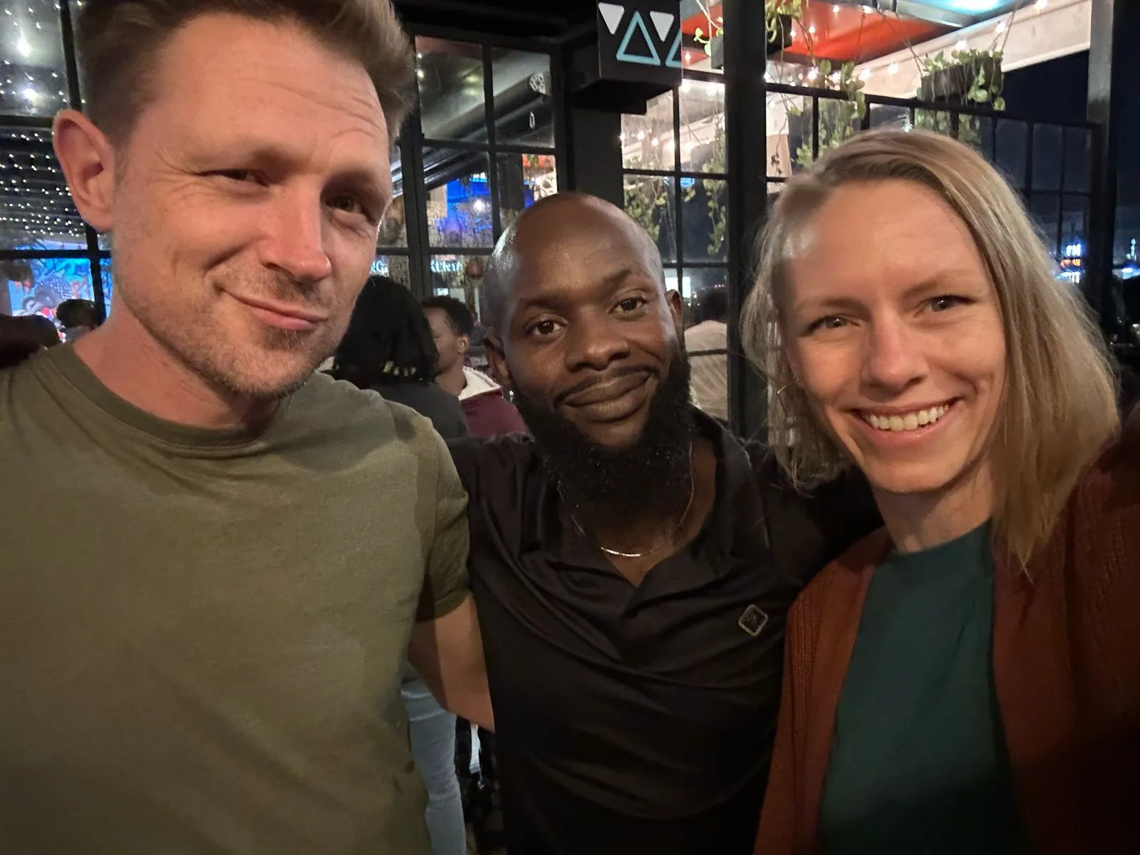 Three people photographed together at an evening industry event